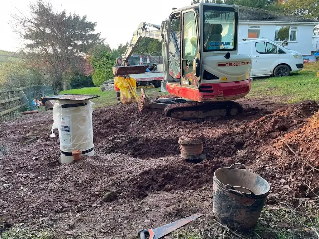 A picture of drainage groundwork with an excavator and tank