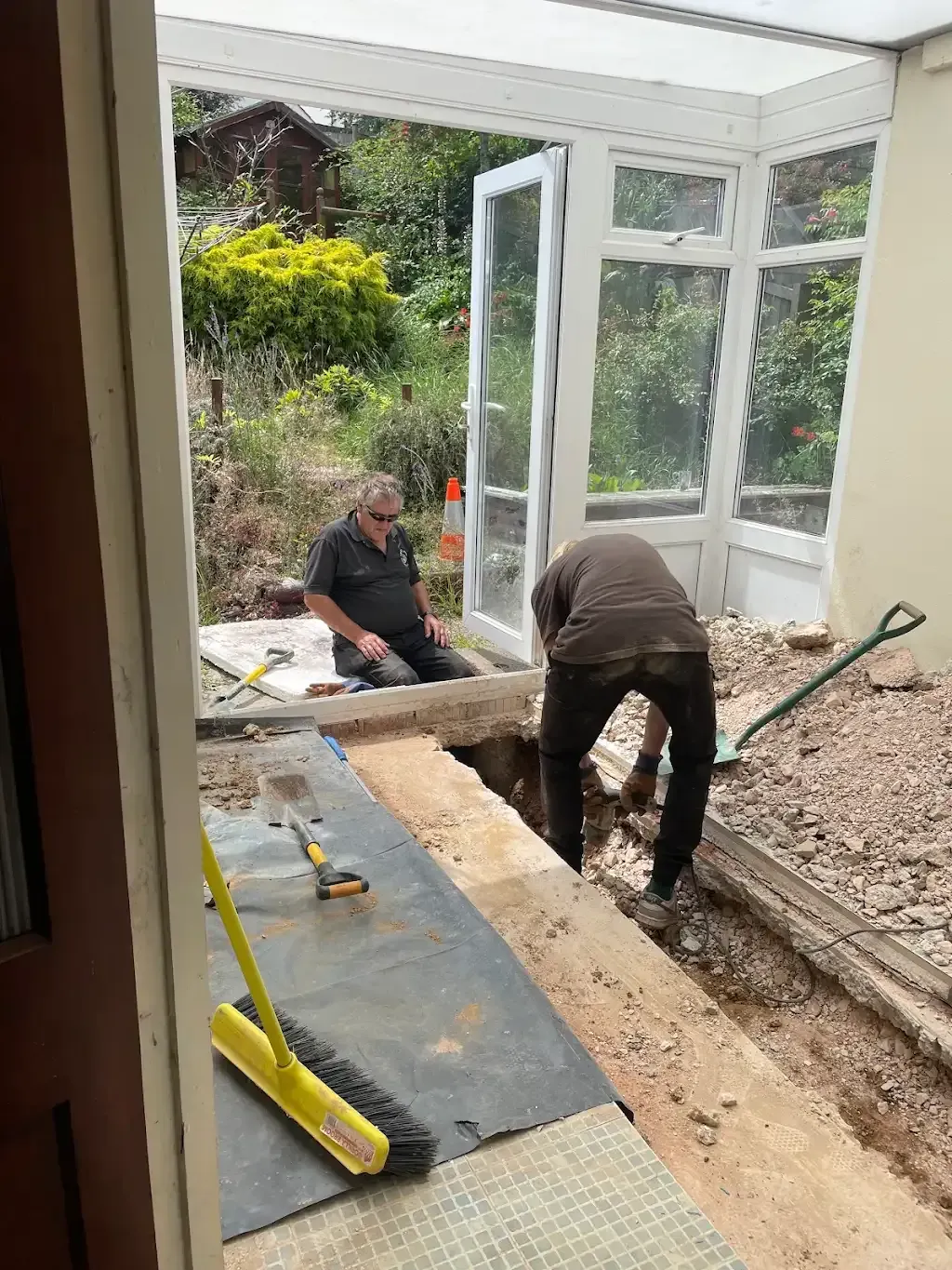Drainage workers removing concrete to access pipes